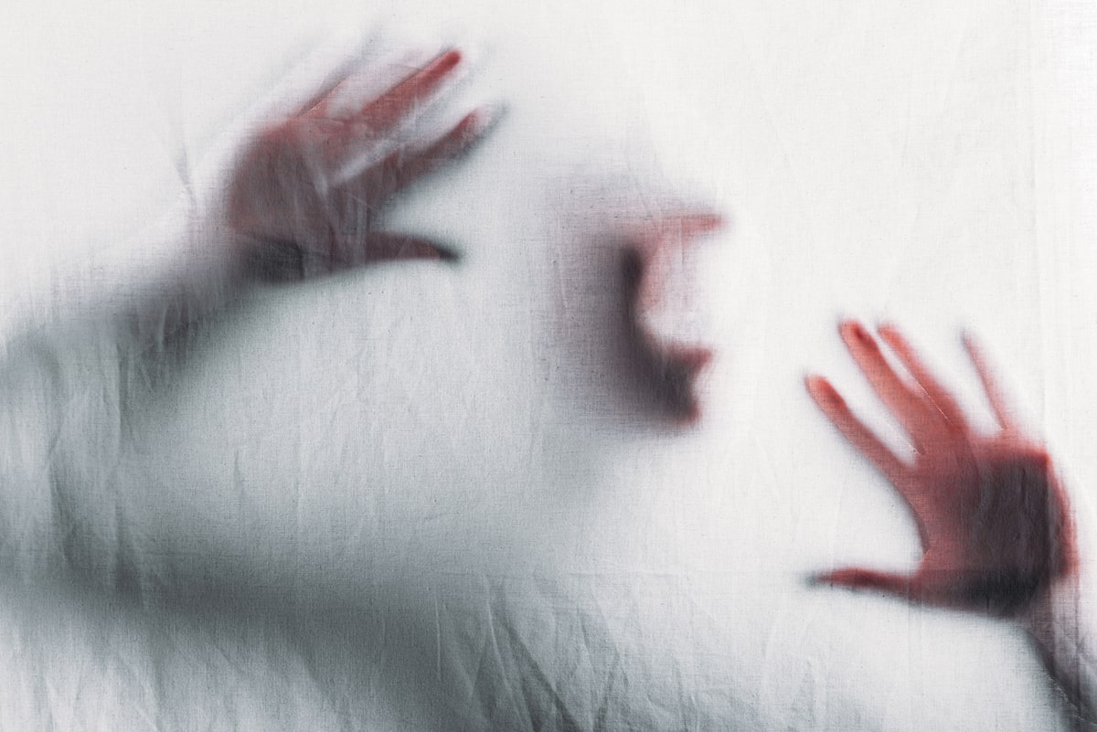 In REM sleep, heightened brain activity can trigger nightmares.